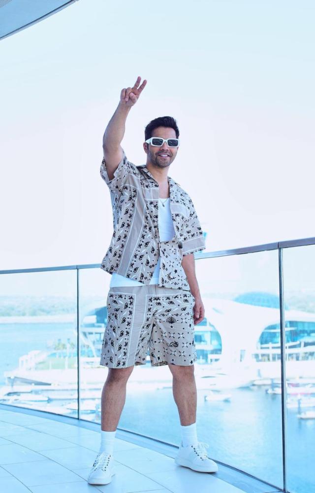 His look is always completed with funky glasses and a silver locket. 