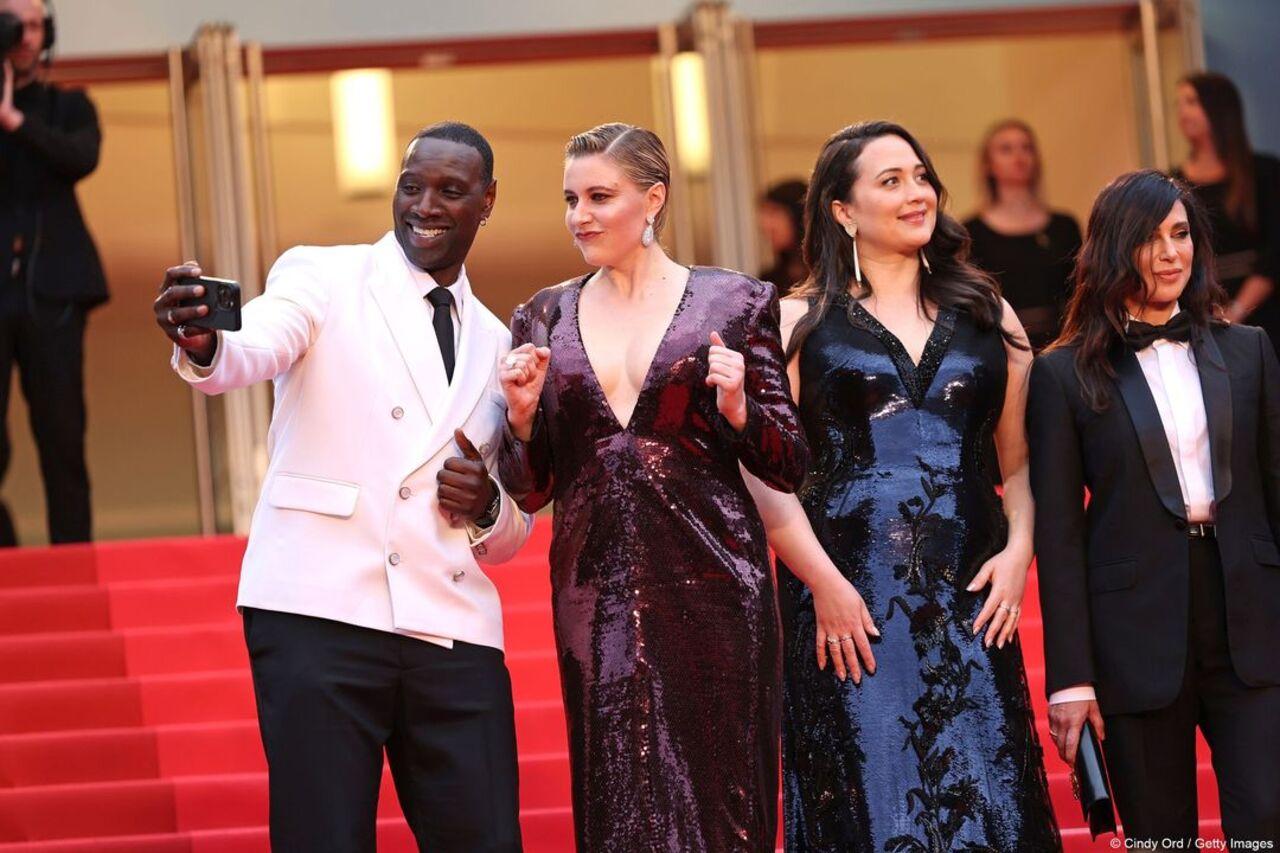 French actor Omar Sy caught in a candid moment with Greta Gerwig on the Cannes red carpet
