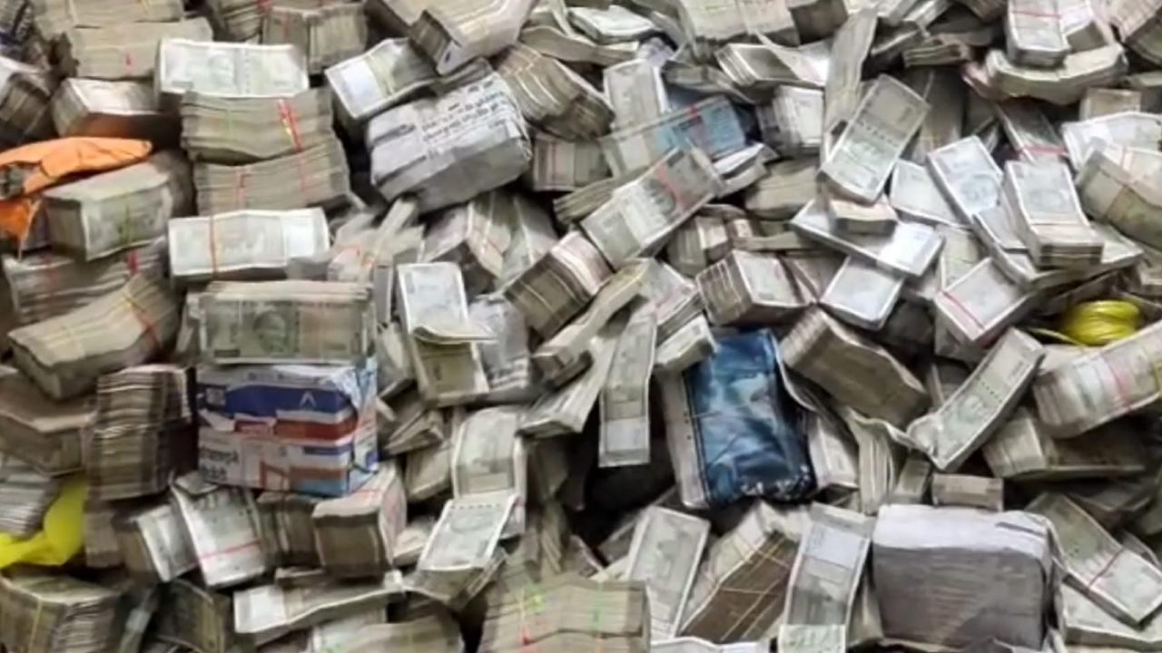 Videos and photos shared by the sources showed officials of the central probe agency taking out wads of currency notes from large bags in a room. Some central force security personnel were also seen