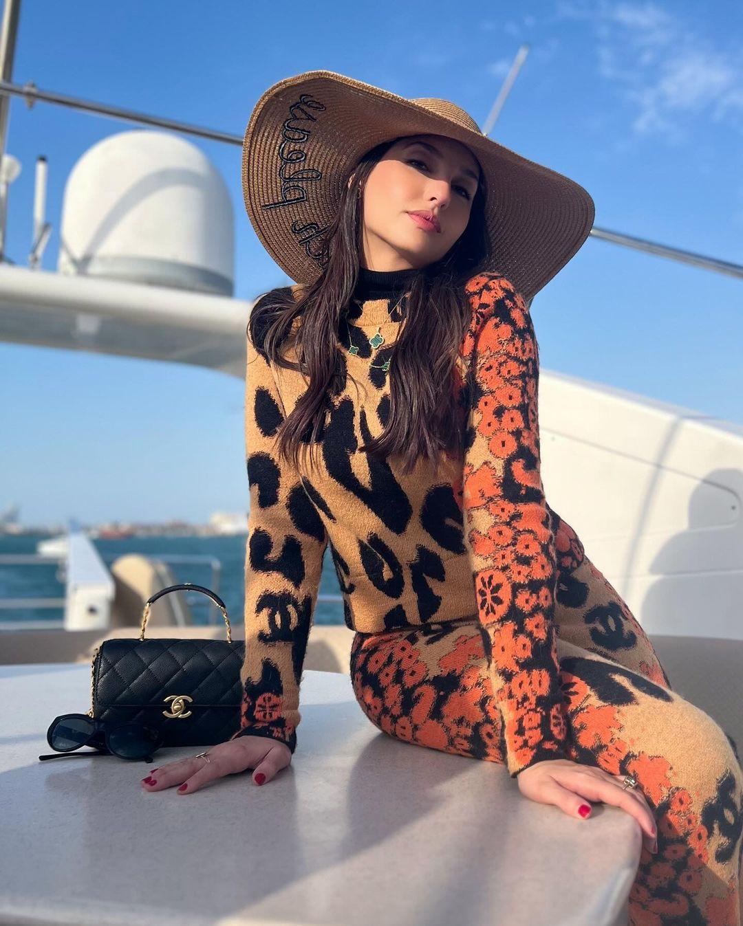 On a summer day, Nora Fatehi demonstrated a casual way to wear a leopard print co-ord set. The dancer rocked a full-sleeved top with large leopard spots.