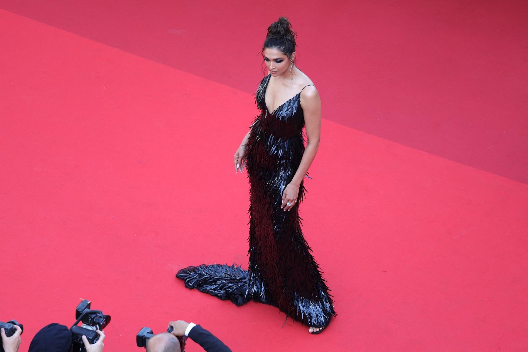The feather-like detailing throughout adds texture, providing depth to the outfit and evoking a lively flapper-esque energy in its movement.