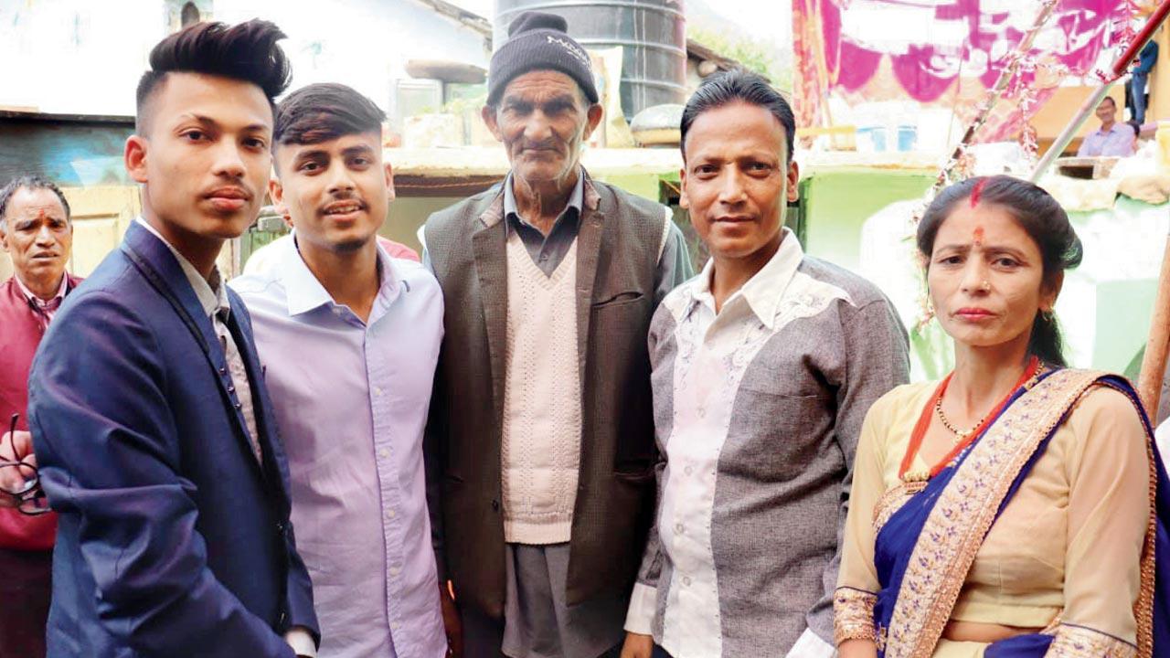 Shubham Rawat (left), with his family. His younger brother Laxman can be seen standing next to him 