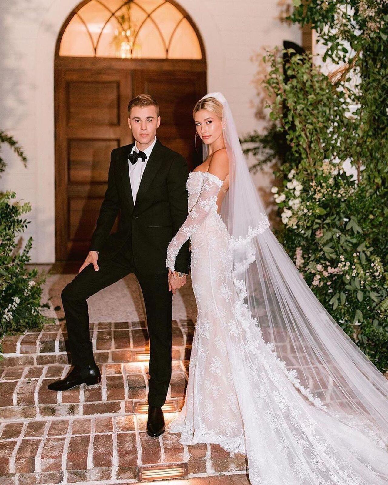 Justin and Hailey Bieber walked down the aisle in 2019 at the Montage Palmetto Bluff Hotel in South Carolina. Hailey wore a custom off-the-shoulder gown by Virgil Abloh, which featured lace and pearl embellishment, long sleeves, corseting through the bodice, and a mermaid skirt and a long tulle train embroidered with 