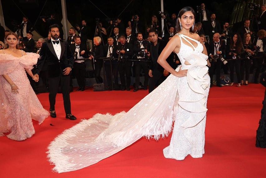 Mrunal Thakur graced the red carpet of the 76th Cannes Film Festival alongside Grey Goose, showcasing three unique looks designed by top Indian designers. This ensemble was a custom white gown by Falguni Shane Peacock, adorned with frills and a signature feathered white train.