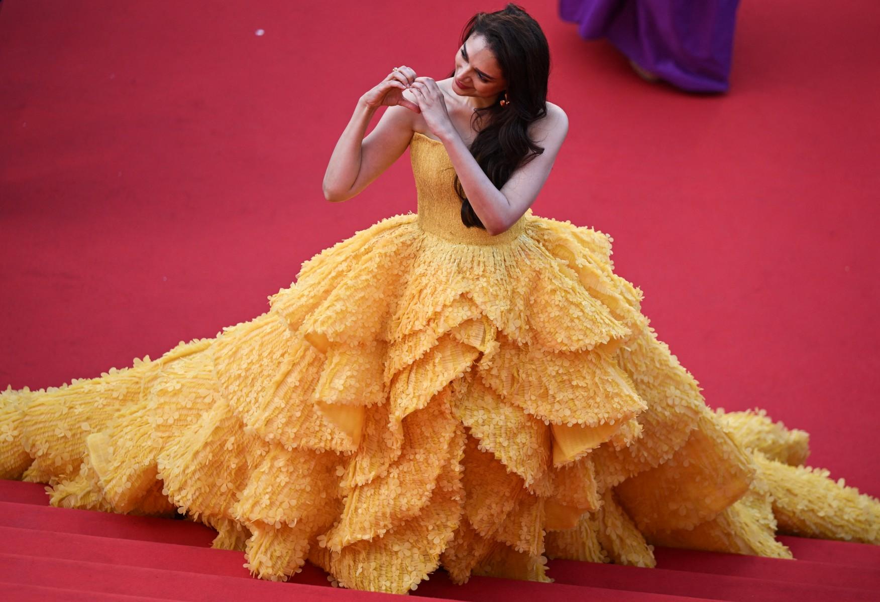 Aditi Rao Hydari looked stunning in a strapless, sweetheart neckline sunshine-yellow ball gown by Michael Cinco. The gown featured a corseted bodice that accentuated her waist and flowed into a voluminous asymmetrical skirt with a grand sweeping train adorned with textured floral embellishments