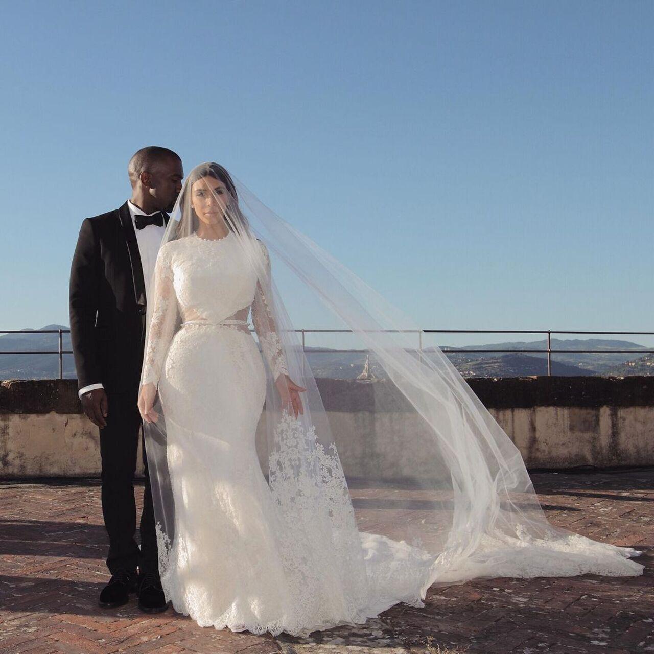 Kim Kardashian and Kanye West tied the knot in May 2014. The fairytale ceremony took place in Italy. Kim wore a custom Givenchy haute couture designed by Riccardo Tisci. It was a full-sleeved mermaid gown with a cut-out at the waist that doubled as a belt. She paired it with an extensive veil. 