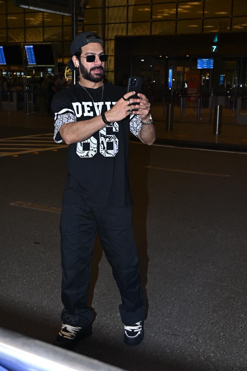 Karan Veer Mehra posed for the paparazzi at the airport before jetting off for Romania