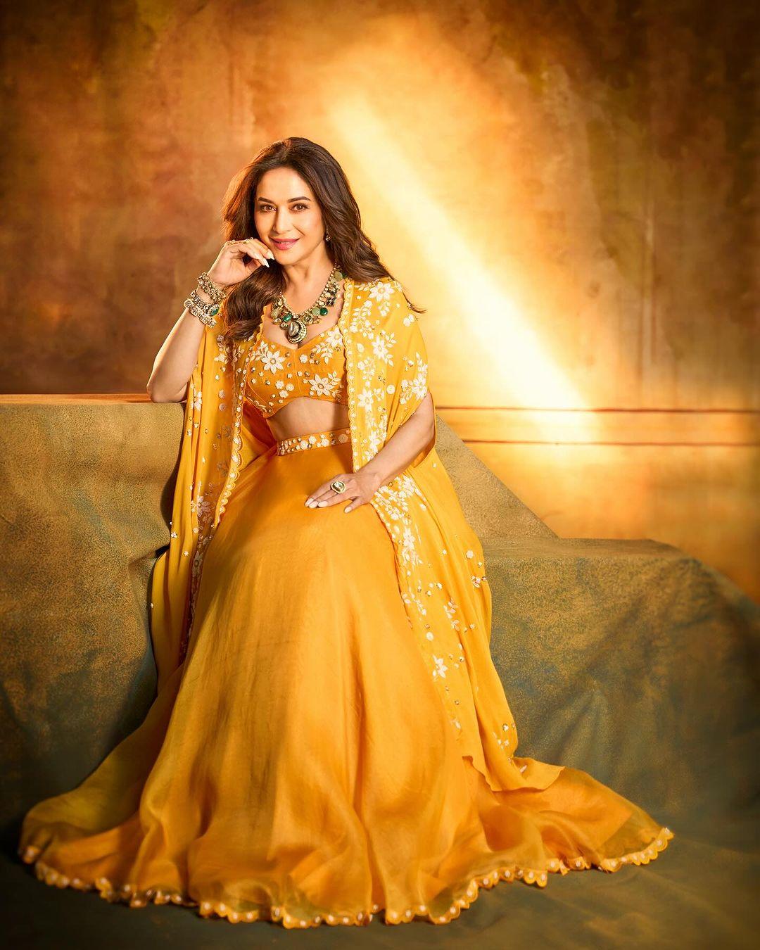 Madhuri Dixit looked stunning in a bright yellow traditional skirt paired with a matching jacket