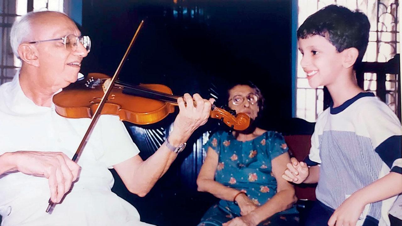 Playing the violin for his wife Homai and a young Zarir