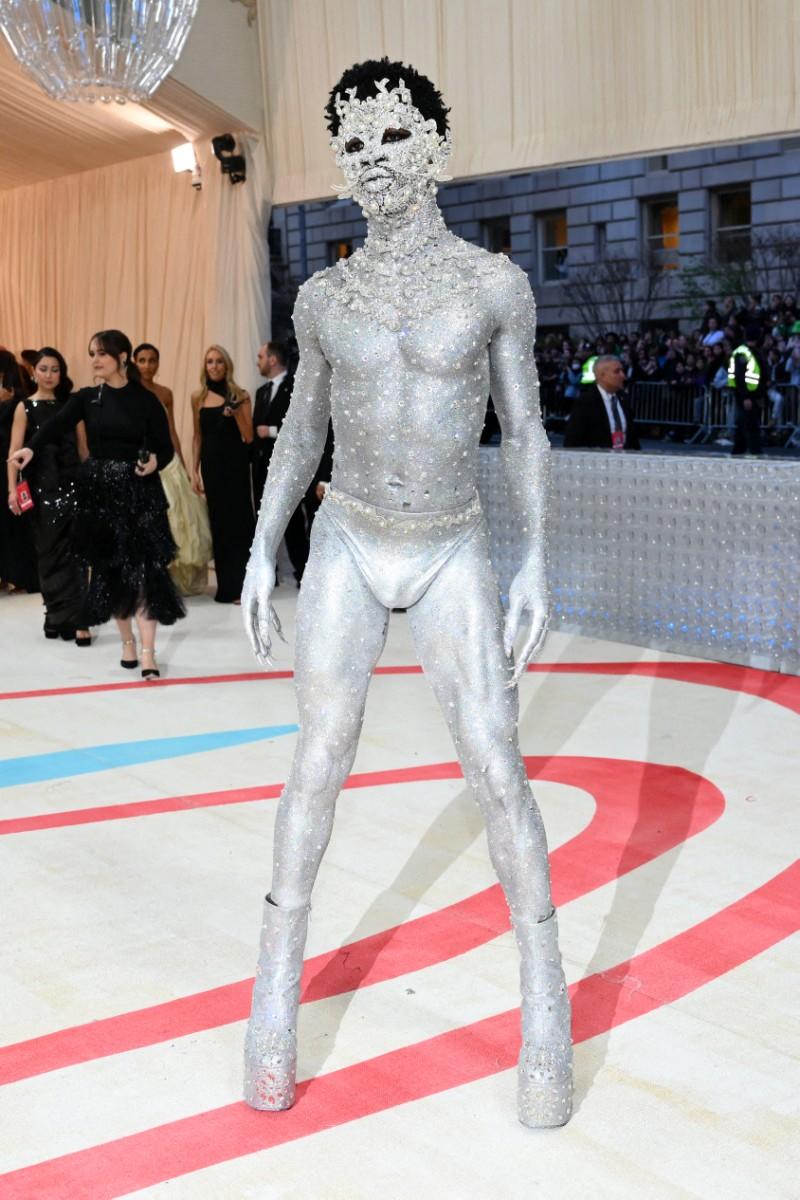 In 2023, Lil Nas X, the Grammy-winning musician, made a bold fashion statement at the Metropolitan Museum of Art. He wore a metallic thong, silver body paint, and a bejewelled face.