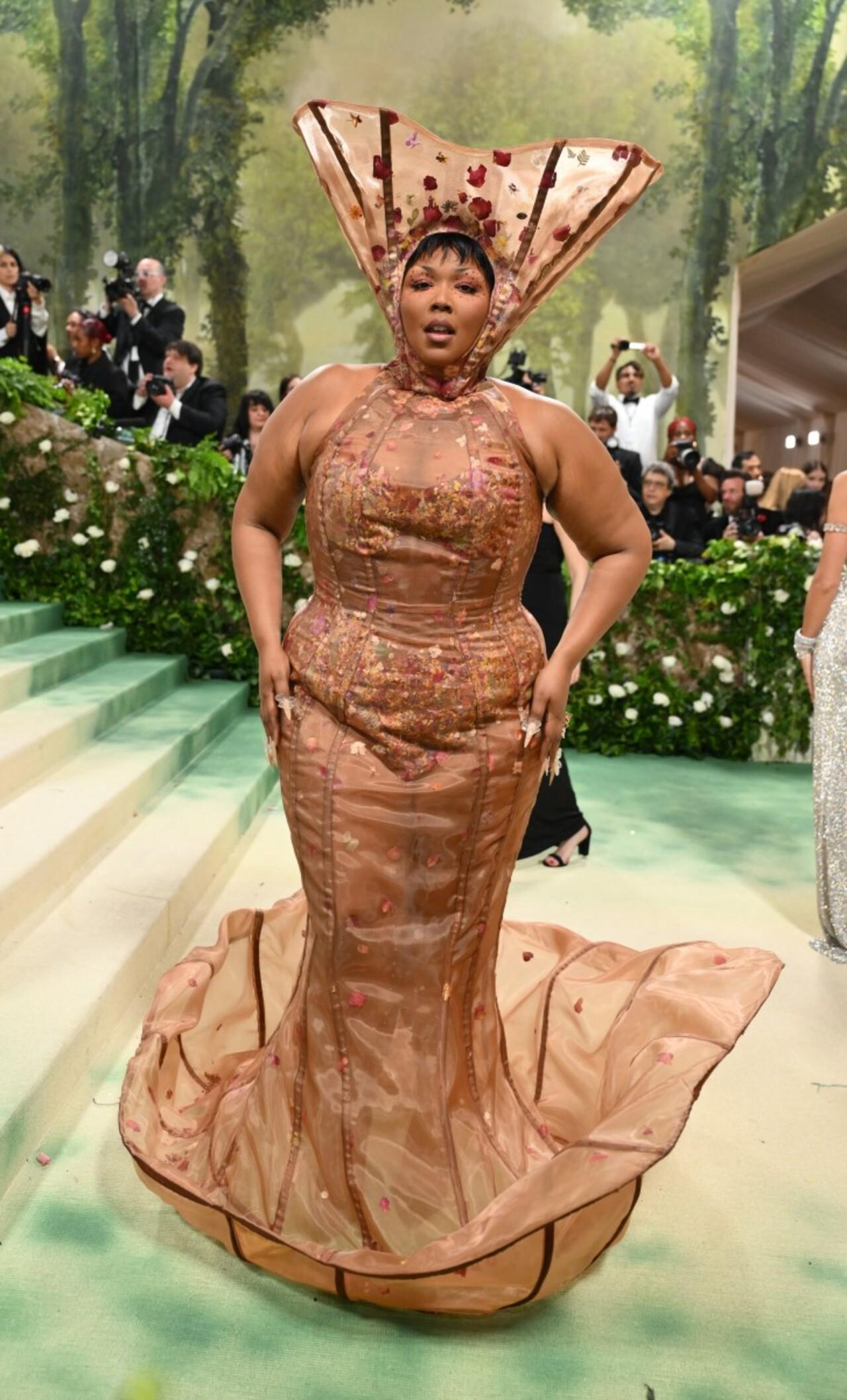 Lizzo wore a nude-coloured corseted gown designed by Paris-based label Weinsanto with a headpiece and flared bottoms making her look like a bloomed flower. 