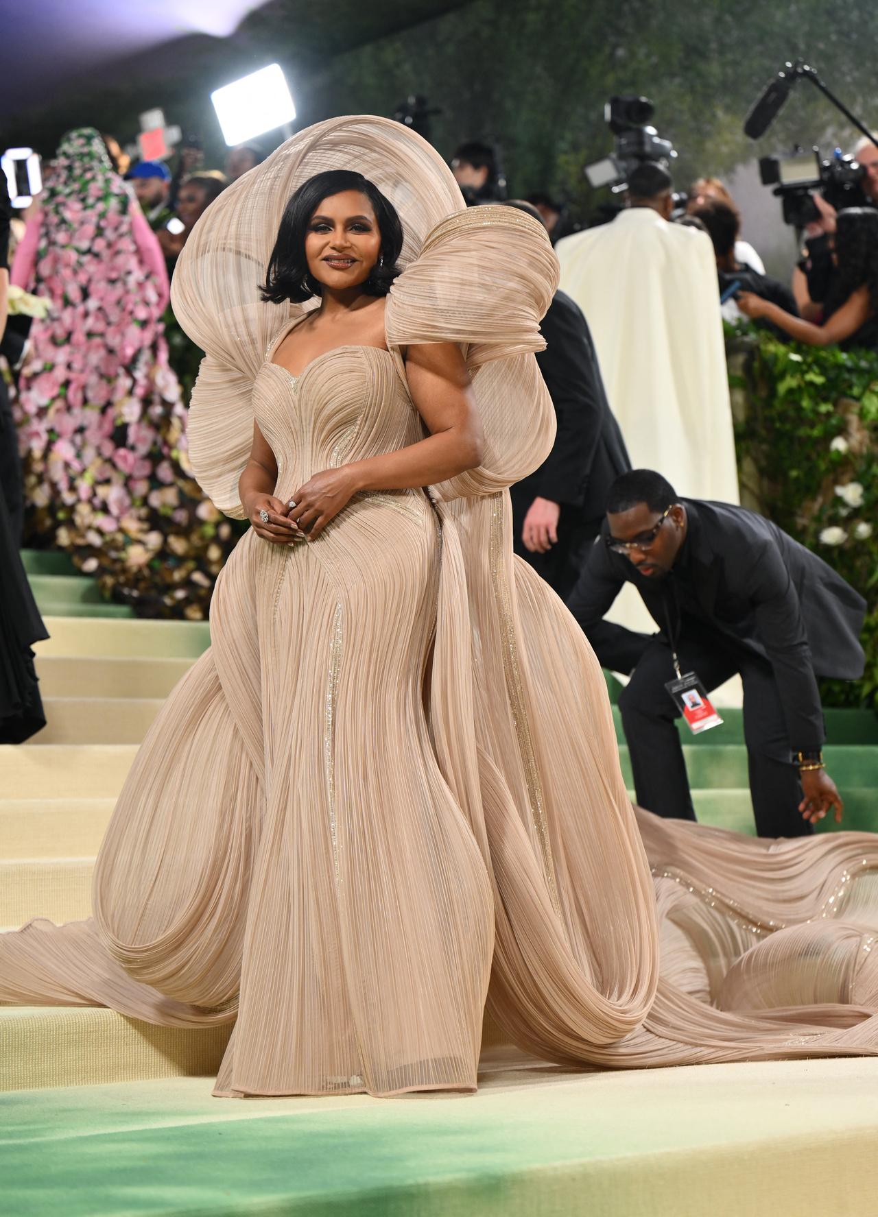 Mindy Kaling turned heads as she strutted the MET Gala carpet in a creation by renowned designer Gaurav Gupta, which was similar to outfits donned by Aishwarya Rai Bachchan and rapper Cardi B in the past. 