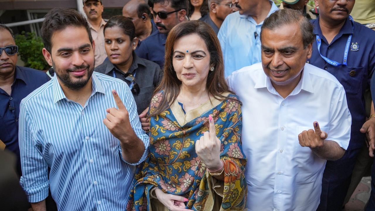 Mukesh Ambani with wife Nita and son Akash after casting votes at a polling booth in Mumbai. Pics/PTI