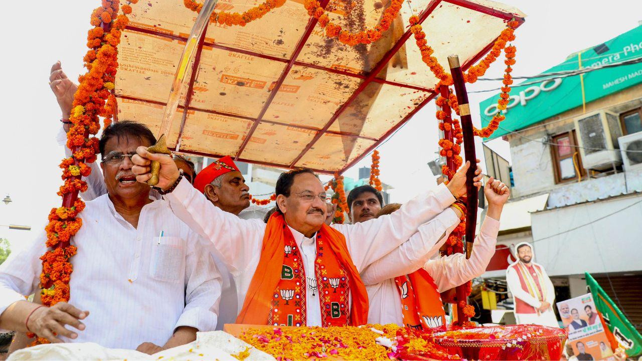 Nadda, accompanied by Arvind Sharma, actively engaged with the crowd from a specially designed vehicle, expressing gratitude and energizing the supporters by showering flowers upon them.