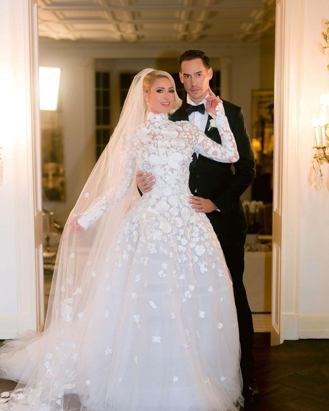 Paris Hilton married Carter Reum in a celeb-studded ceremony at her late grandfather's sprawling Bel-Air estate. For their 'I dos', Paris wore the glamorous custom Oscar de la Renta gown featuring long sleeves covered in floral embroidery with a matching veil.
