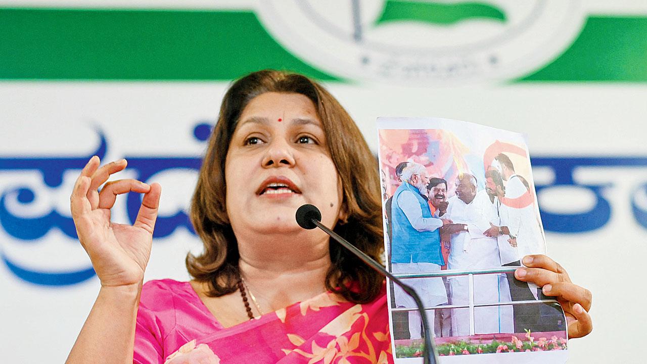 Congress spokesperson Supriya Shrinate shows a photograph featuring JD(S) MP Prajwal Revanna. Pic/PTI 