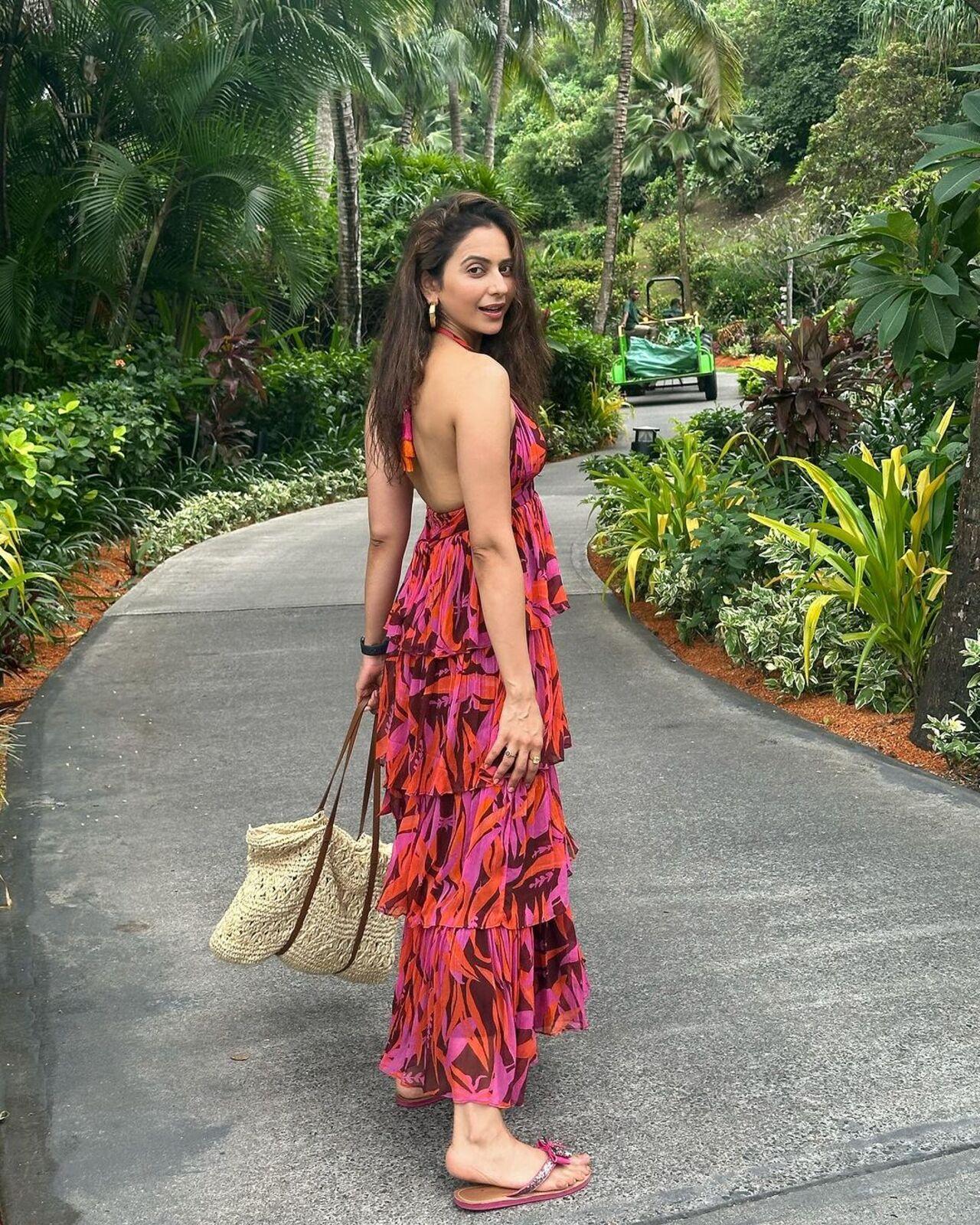 She also sported a pink and orange layered maxi dress with a halter neck for her outing. 