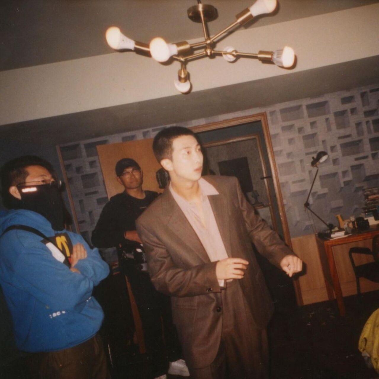 The other shows him dressed in a two-piece suit looking dapper as always. 