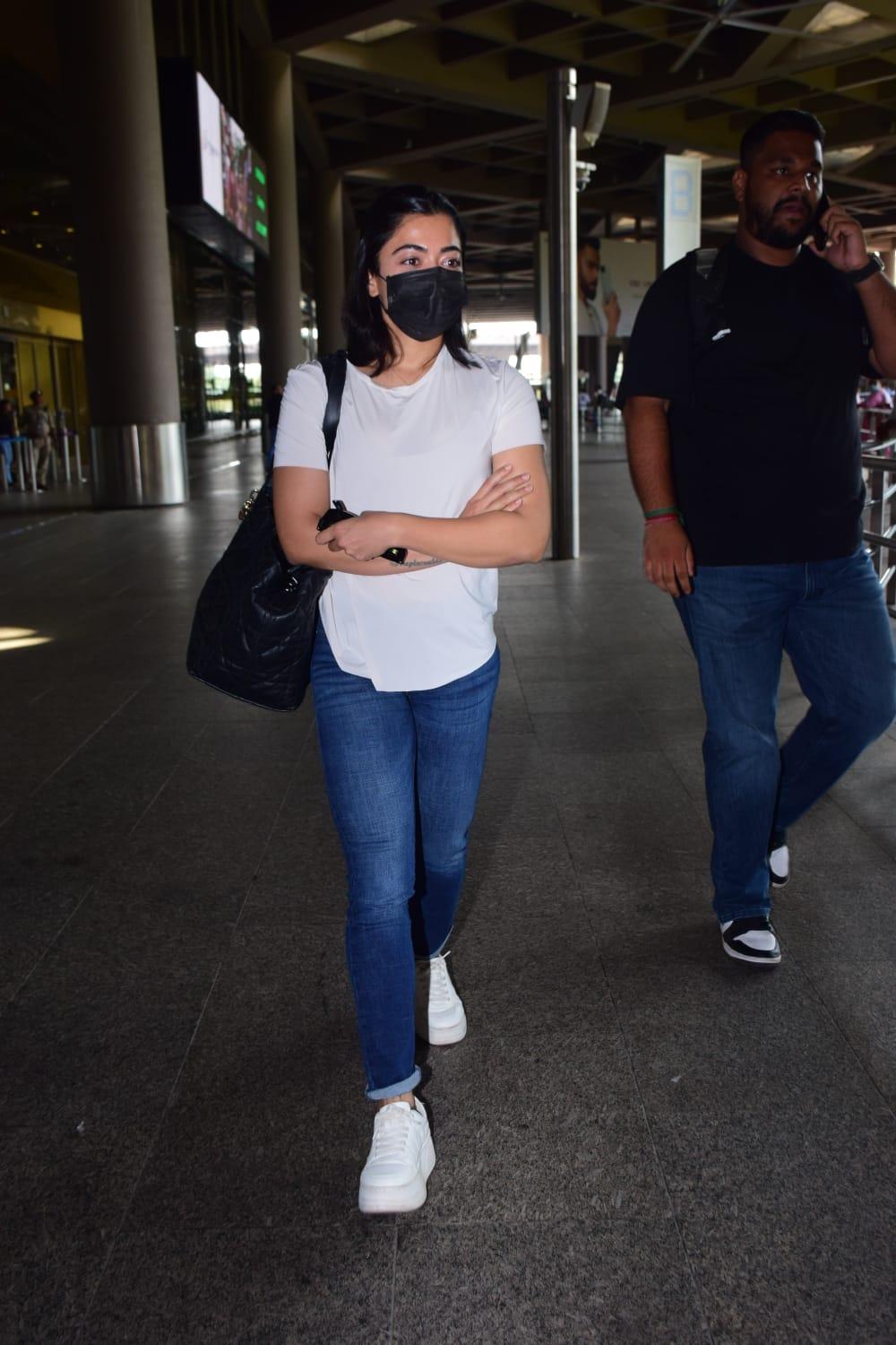 Rashmika Mandanna opted for simple white T-shirt and blue jeans for her airport look