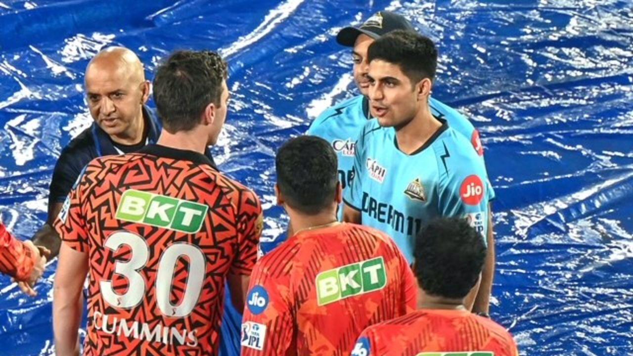 GT captain Shubman Gill (right) and his SRH counterpart Pat Cummins greet each other after their match was abandoned due to rain in Hyderabad on Thursday. PIC/AFP