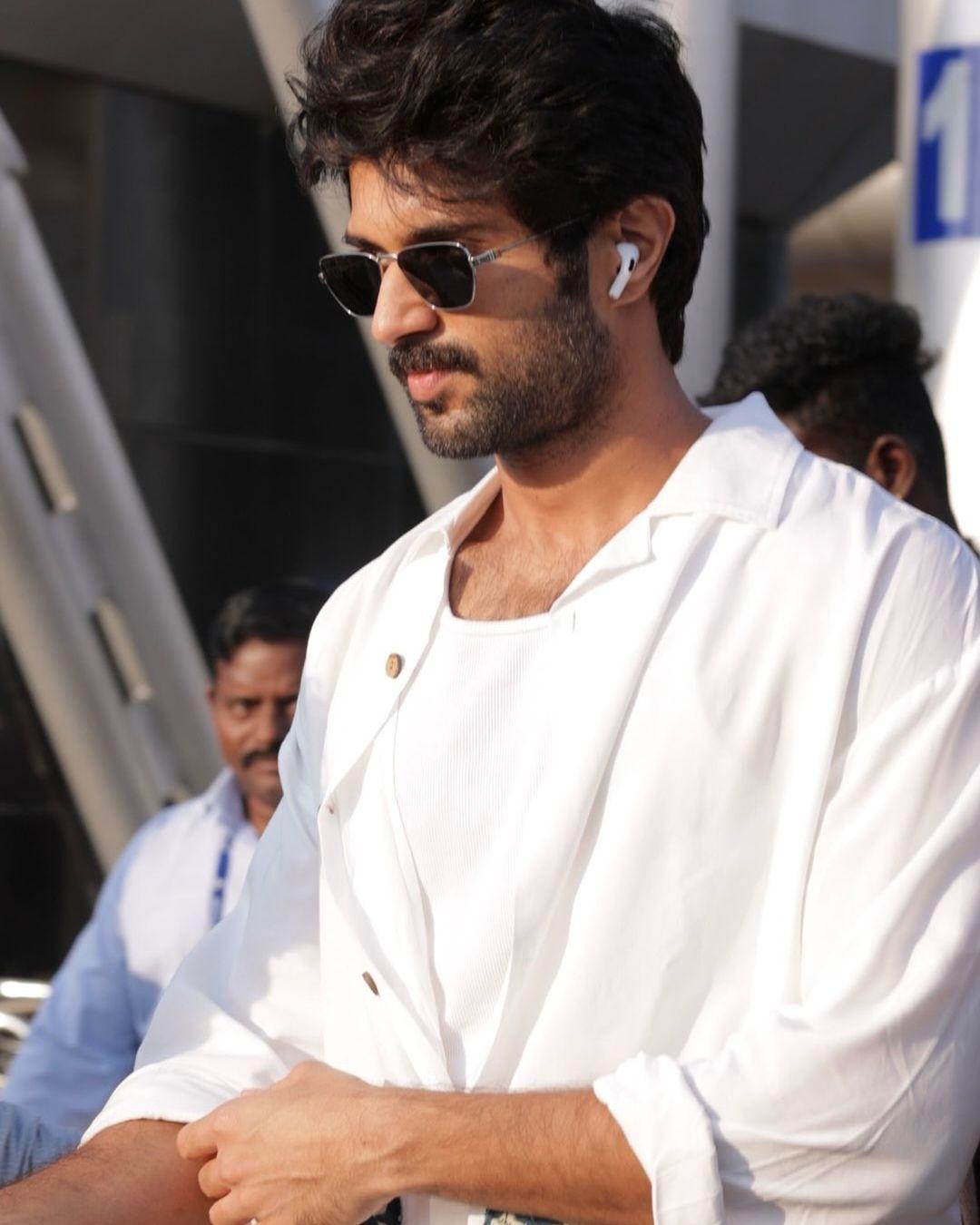 Vijay Deverakonda's summer look is effortlessly cool with a loose, unbuttoned white shirt layered over a crisp white undershirt.
