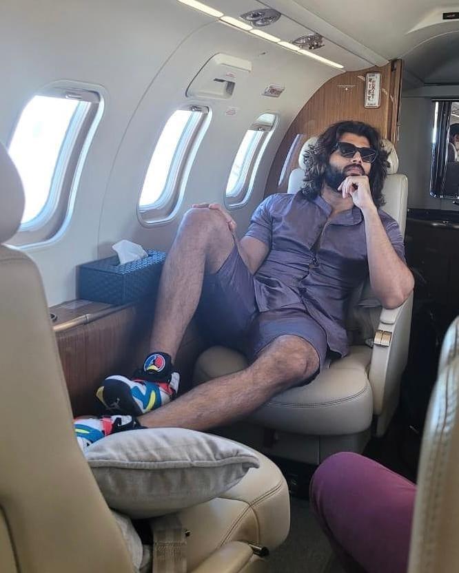 Vijay Deverakonda's summer ensemble is effortlessly cool with a purple shirt paired casually with shorts.
