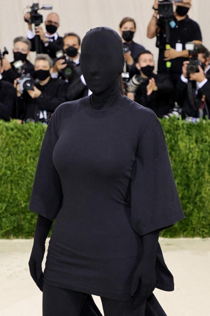 Kim Kardashian's outfit at the Met Gala was quite unconventional. She wore a black Balenciaga haute couture gown with a matching mask and train, completely hiding her face.