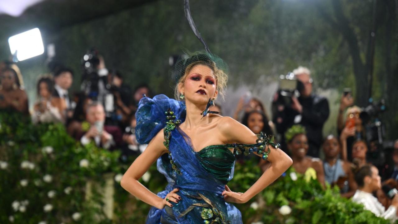 The haute couture ensemble boasted a sage lamé and organza bias-cut dress layered over a duchesse satin corset, adorned with hand-painted metallic crin, iridescent organza, and a meticulously hand-embroidered corsage. Pic/AFP