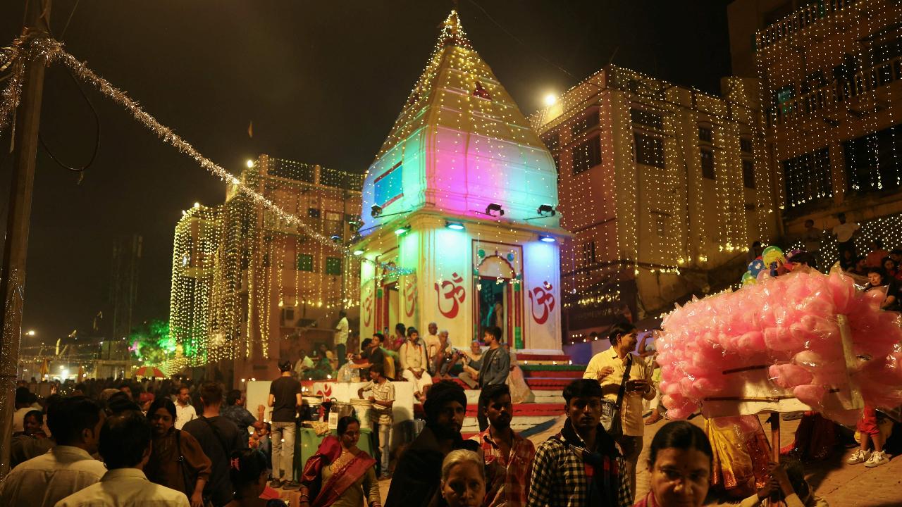 Devotees gather to celebrate the festival on the banks of the river Ganges at Kshemeshvar Ghat in Varanasi