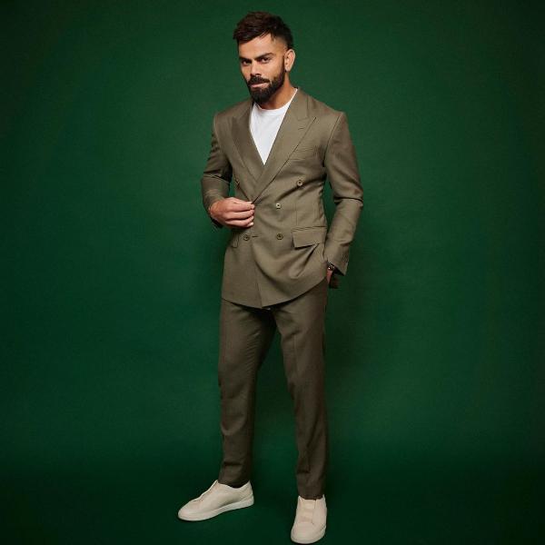 Kohli pairs matching pants and blazer with a casual white tee which adds a playful touch to the otherwise formal outfit. White sneakers complete the look. 