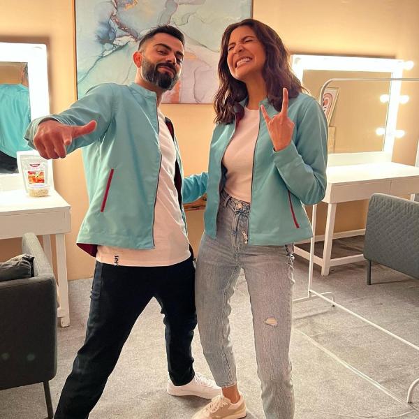 Here, Virat Kohli twins with wife Anushka Sharma in a casual white tee and blue jacket. 