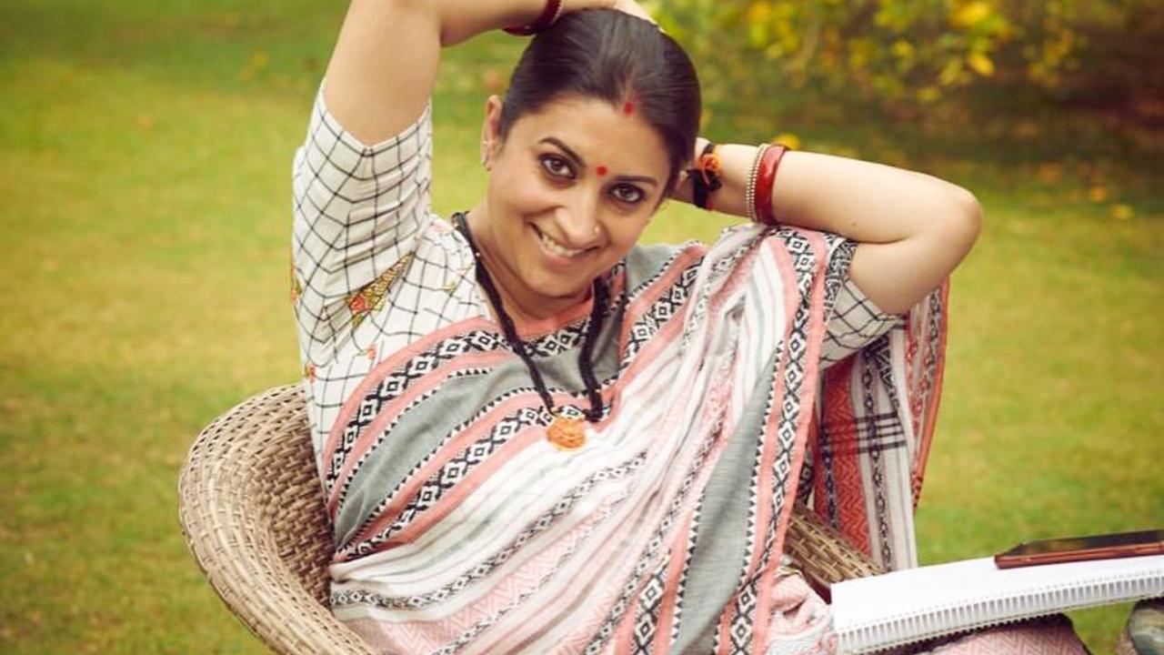 In this picture shared by her, Irani is wearing a patterned saree with hues of white, black, pink and grey. She has paired it with a chequered blouse of the same hues. 