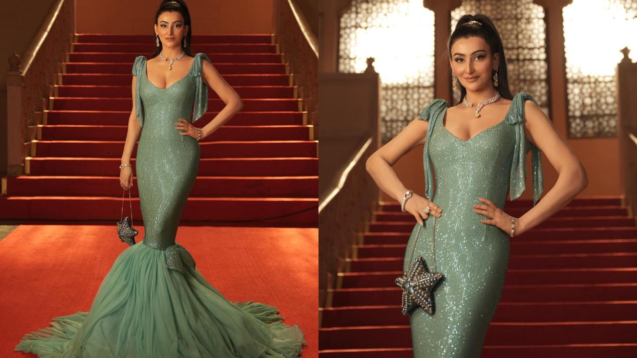 In this picture, she wears an elegant mermaid gown, paired with fine jewellery. A high ponytail completes her look. 