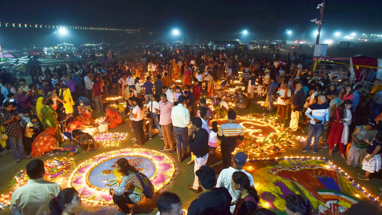 Devotees light diyas on the occasion of Dev Deepawali and Kartik Purnima festivals at Sangam, Prayagraj