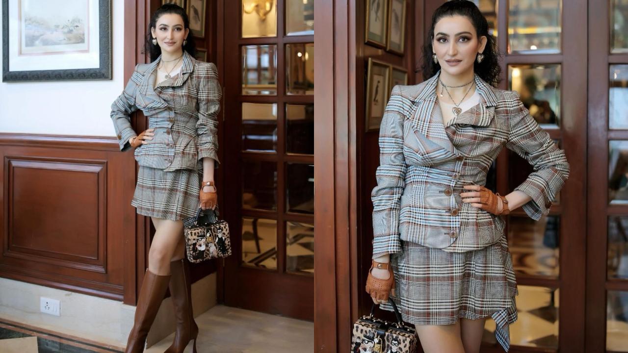 Passi looks casual outing-ready in this chequered co-ord set, which she paires with brown gloves and high-heeled boots. 