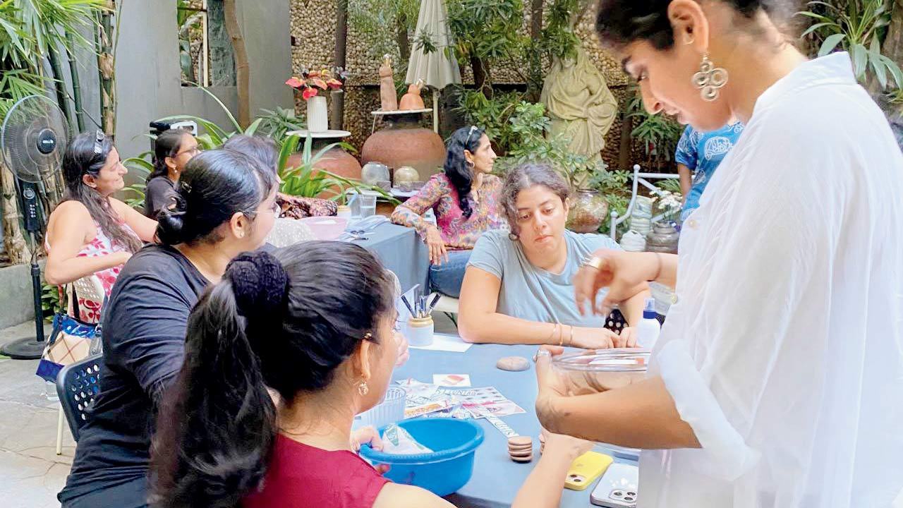 People work on clay kulhads at an earlier workshop