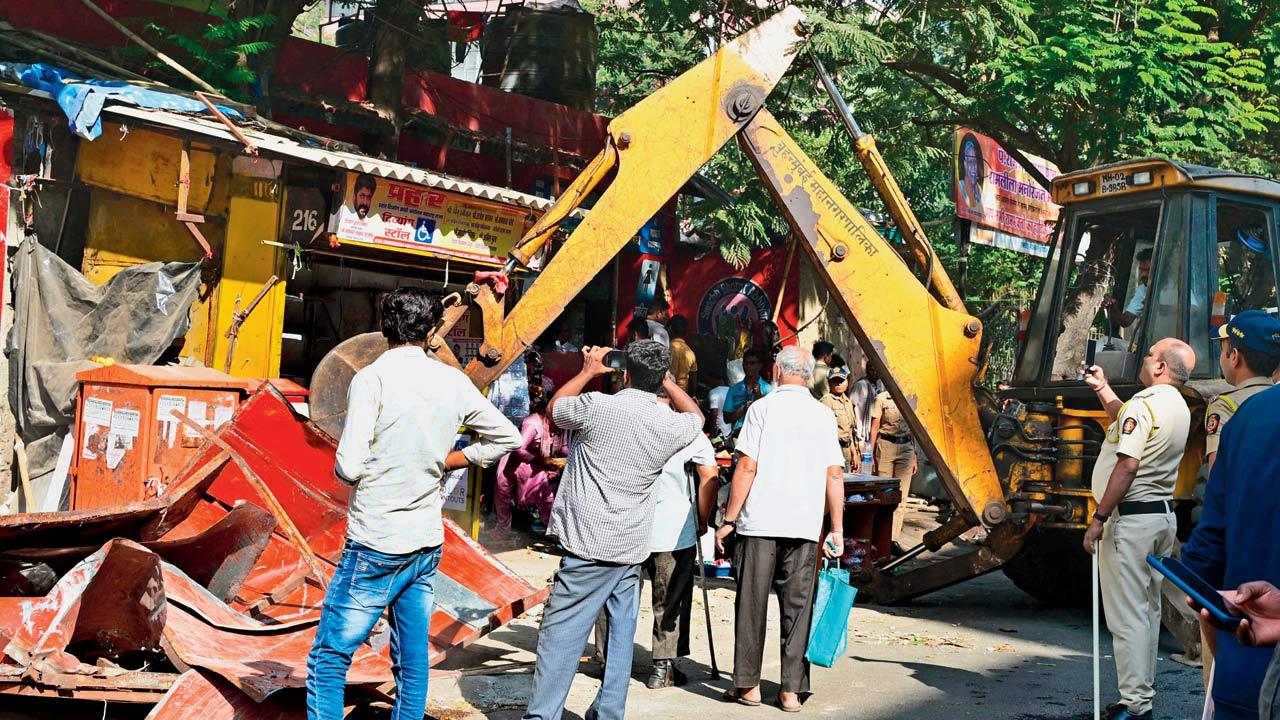 The authorities demolish illegal structures on the road on Friday. Pics/Nimesh Dave