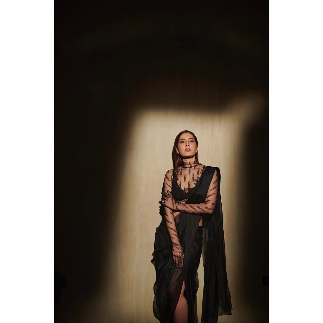 In this look, the actress wore a unique black saree featuring a thigh-high slit and paired it with a strappy blouse.  