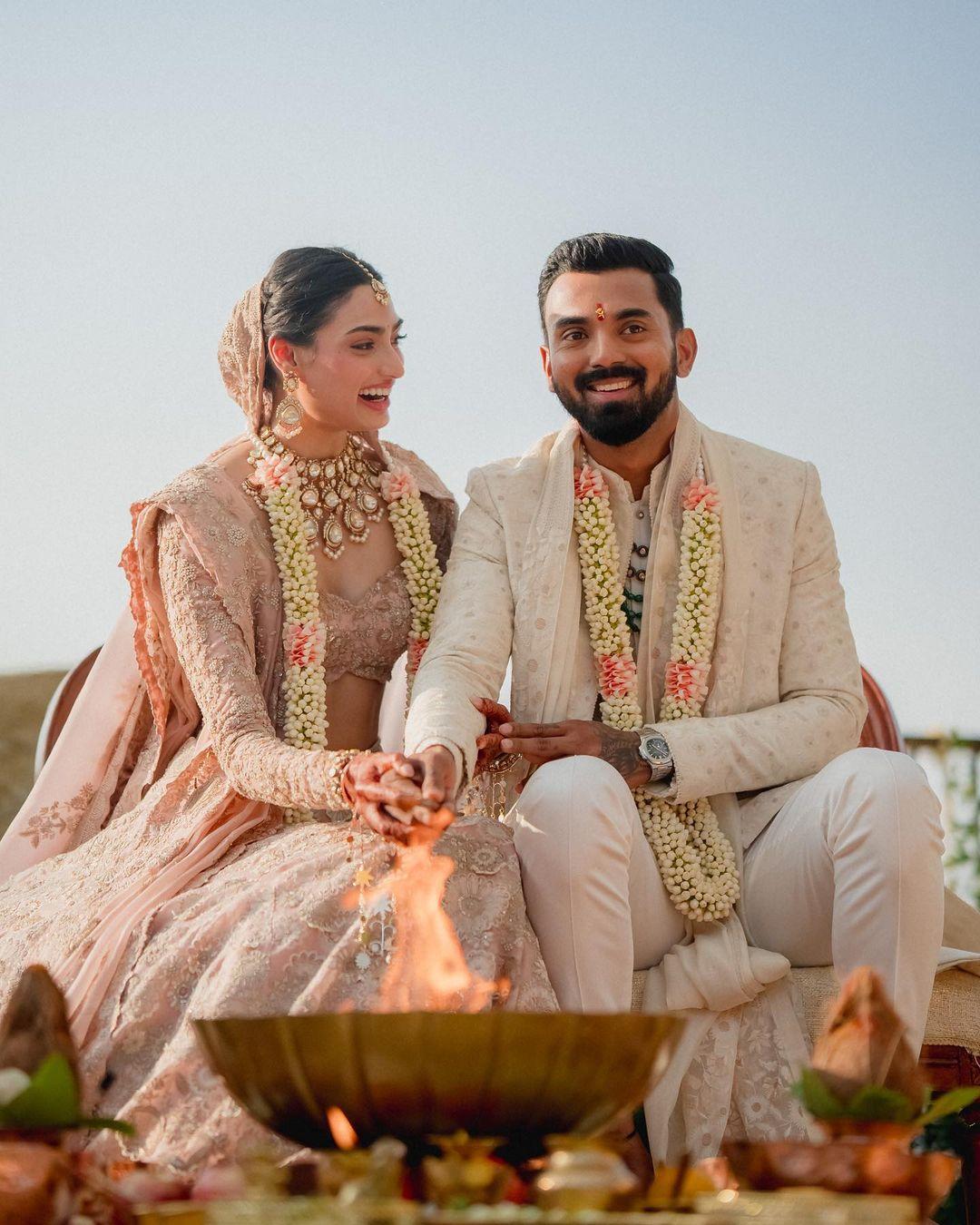 The two opted for stunning pastel outfits that radiated elegance. Athiya looked resplendent in an old-rose pink lehenga, while her groom, cricketer KL Rahul, perfectly complemented her look in an ivory sherwani. 