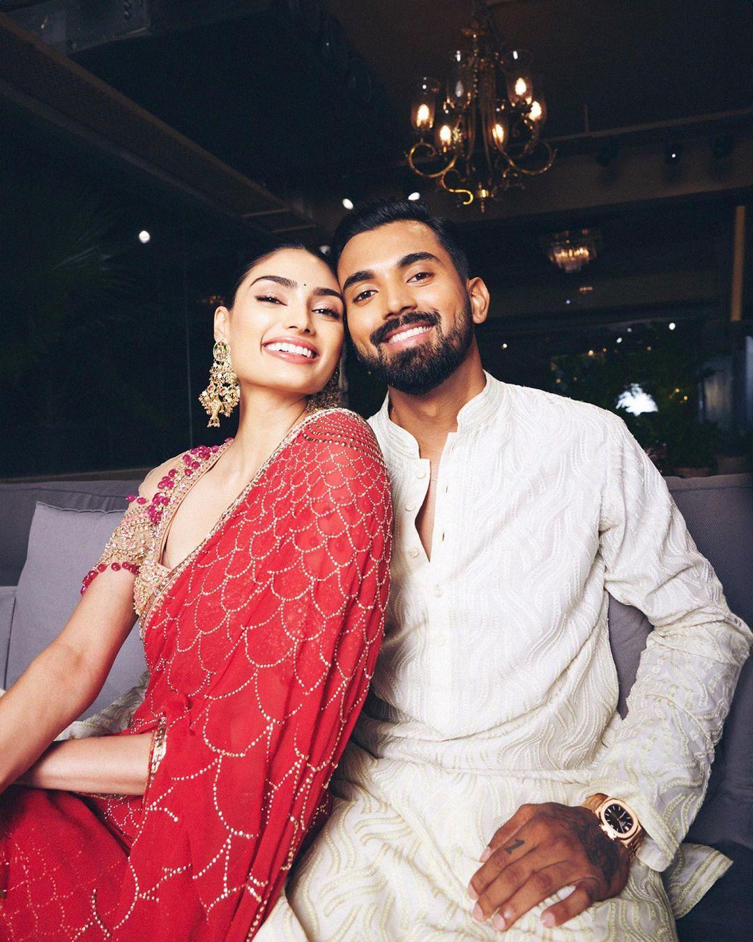 Athiya struck a playful, goofy pose in yet another shot. She wore a beautiful red saree adorned with intricate designs, while Rahul complemented her in a classic white kurta. The couple's lightheartedness and joy shine through in this picture.