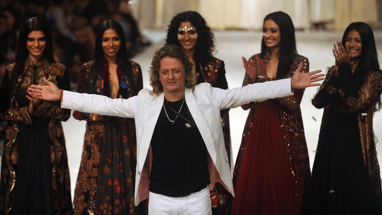 The Indian fashion designer was known for his intricate use of rich fabrics like velvet and brocade adorned with signature flower and peacock motifs.
