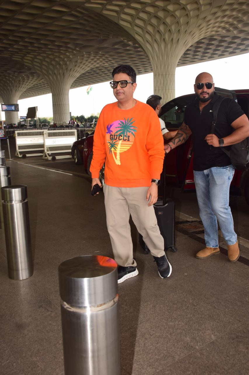 Bhushan Kumar wore a stylish orange sweatshirt paired with jeans for his airport look