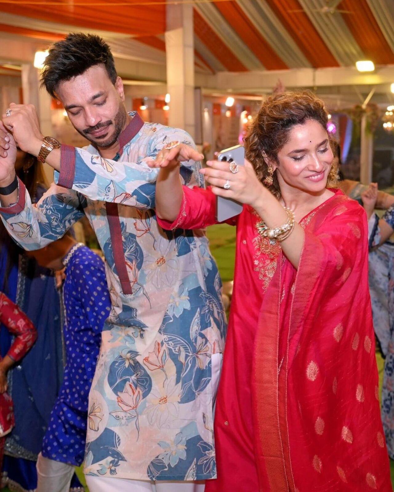 In one image, filled with devotion, Ankita and Vicky are seen dancing with their hands in the air.
 