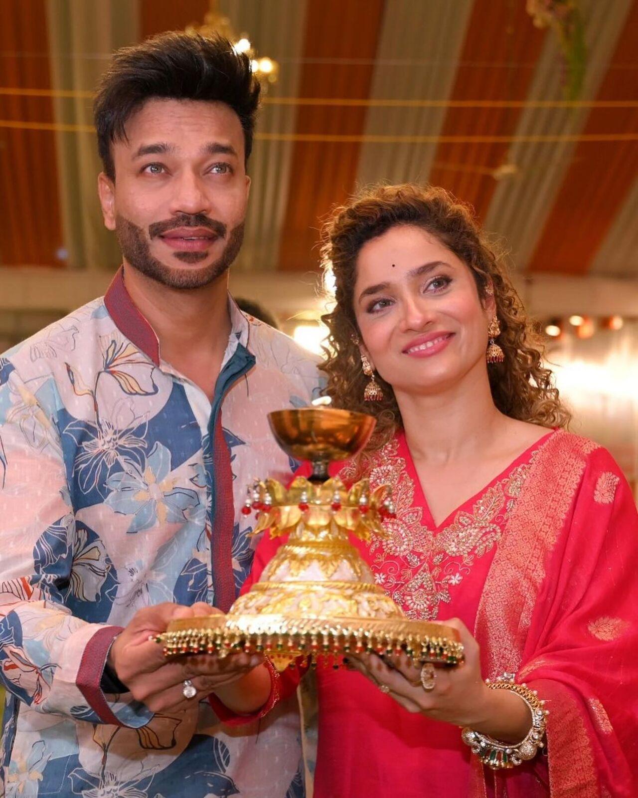 Another set of pictures shows the couple performing a puja together. Vicky is seen wearing a white printed kurta, while Ankita stuns in a red suit featuring gorgeous embroidery.