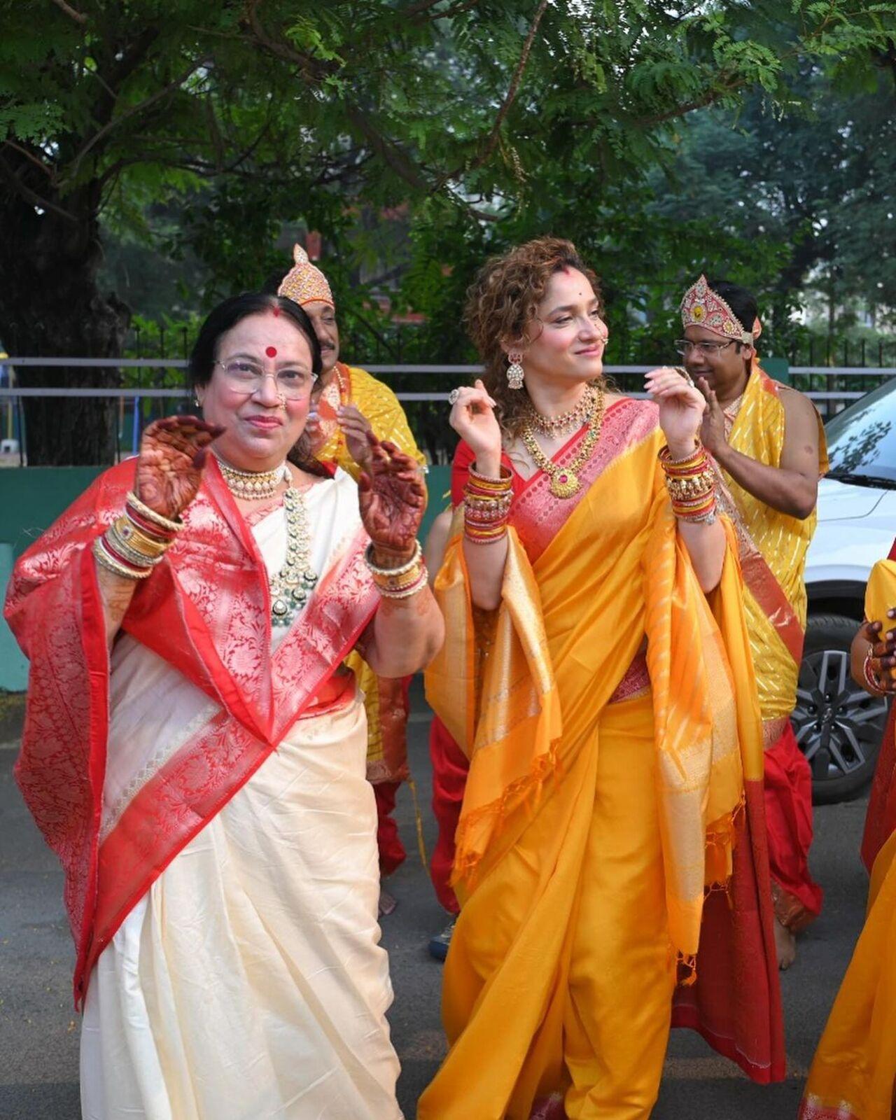 In another, Ankita is seen dancing with her mother-in-law, who is also dressed in a white saree with a red border