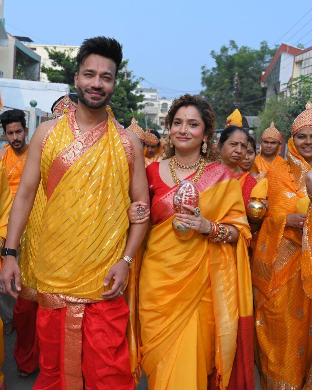 In another picture, Vicky Jain is all smiles while Ankita Lokhande is seen walking on the road with a kalash in her hands. The couple walks barefoot in honor of their culture