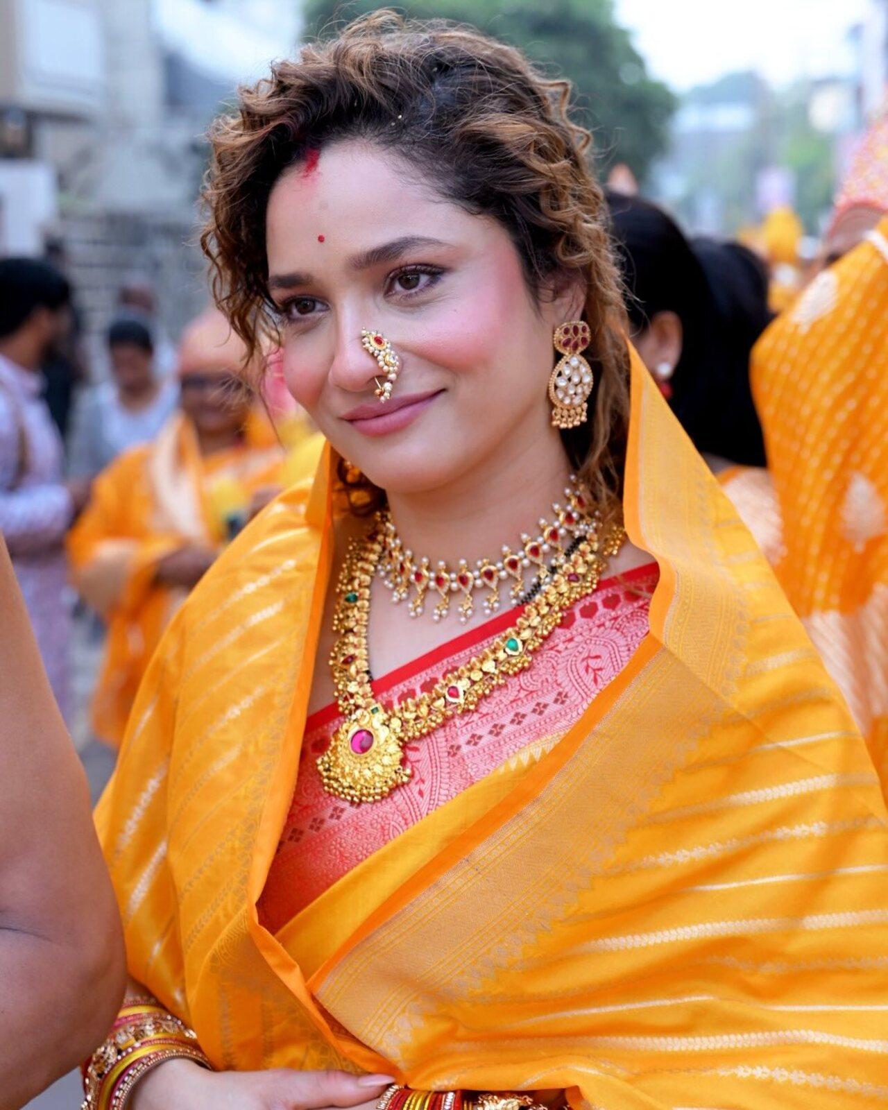 Ankita Lokhande looks beautiful as she accessorizes her ethnic look with gold necklaces, a nath, and earrings.
 