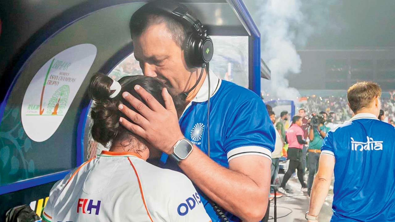 Chief coach Harendra Singh congratulates star striker Deepika. Pics/Hockey India