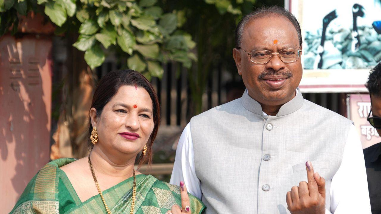 Maharashtra BJP President and party's candidate from Kamthi, Chandrashekhar Bawankule and wife show their inked finger after casting a vote at a polling station in Nagpur (Pic courtesy: PTI)