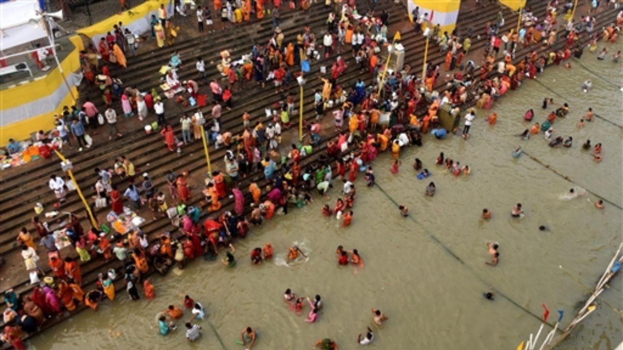 Devotees take a holy dip in the Ganga river during the start of the 4-day Chhath Puja festival, in Patna.